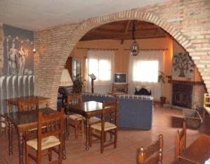 a dining room with a table and a brick wall at Mansió De La Plata in Peñacaballera