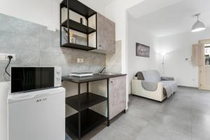 a living room with a tv and a table and a couch at Casa Vacanze Sa Domixedda in Guspini