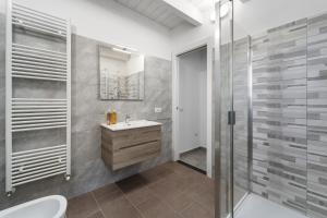 a bathroom with a sink and a shower at Casa Vacanze Sa Domixedda in Guspini +18 photos