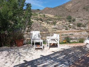 two chairs sitting next to each other on a patio at Cortijo Aldamuz-VTAR102 in Oria