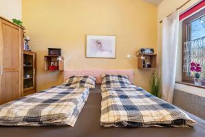 a bedroom with two beds and a window at all u need 4 holiday - fewo44 in Mühlthal