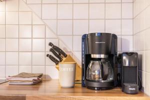 a coffee maker and a coffee cup on a counter at Kristiania Apartement Typ B in Siusi