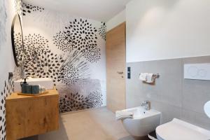 a bathroom with a shower and a toilet and a sink at Kristiania Apartement Typ B in Siusi +30 photos