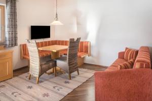 a living room with a table and a couch at Appartement Julia in Achenkirch