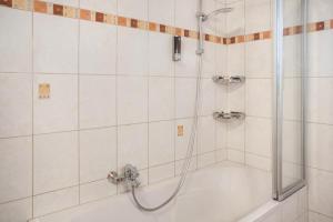a bathroom with a shower with a tub at Appartement Julia in Achenkirch +10 photos