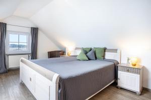 a bedroom with a large bed and a window at Apfelhof Maurer in Lindau