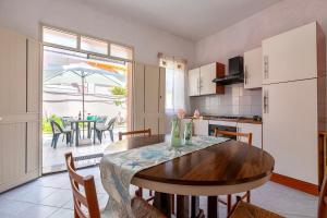a kitchen with a wooden table and a kitchen with a table at Casa Loretta 3 in Valledoria