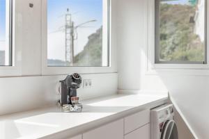 a kitchen with white counters and a sink at Casa Eloisa in Teror