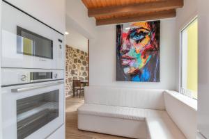 a living room with a tv and a painting on the wall at Casa Eloisa in Teror