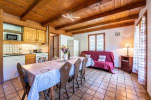 a kitchen and dining room with a table and chairs at Chalet de la Marmotte in Crest-Voland