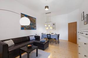 a living room with a couch and a table at Apartment City Leben in Nordhausen +17 photos
