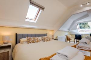 a bedroom with a large white bed with a window at Le Verger Chambres d'hotes in Ségur-le-Château