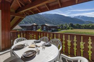 a table and chairs on a balcony with a view at Appt le grand Tetras D20 in Samoëns