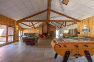 a large room with billiard tables and ping pong tables at Appt le grand Tetras D20 in Samoëns
