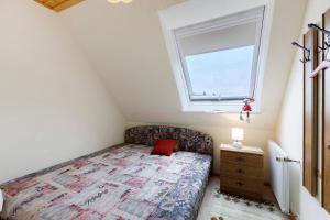 a small bedroom with a bed and a window at Ferienwohnung Haus Barbara in Bräunlingen
