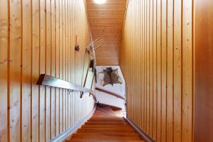 a staircase in a room with wooden walls and wooden floors at Ferienwohnung Haus Barbara in Bräunlingen