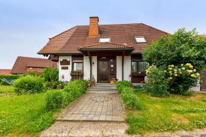 a house with a brick walkway in front of it at Ferienwohnung Haus Barbara in Bräunlingen