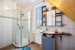a bathroom with a shower and a sink at Haus Übersee Wohnung Sansibar in Travemünde +16 photos