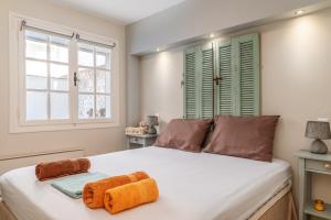 a bedroom with a bed with two towels on it at Waterfront Masterpiece in Tinos