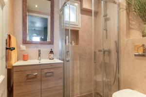 a bathroom with a shower and a sink at Waterfront Masterpiece in Tinos