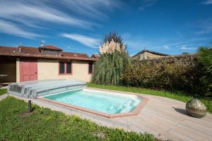 a swimming pool in the yard of a house at Maison avec piscine in Marciac