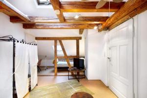 a room with wooden ceilings and a white door at Vogelsberger Bett 5 die 2 in Alsfeld