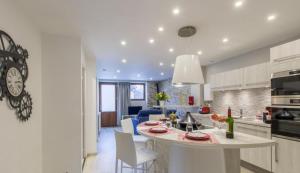 a kitchen and living room with a table and chairs at Le Clos Savoie Lorraine in Thônes +18 photos