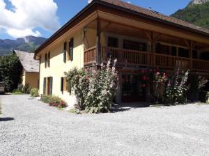 a large building with flowers in front of it at Le Clos Savoie Lorraine in Thônes