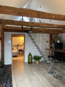 a living room with a spiral staircase in a house at Rosenzauber-Seeromantik in Weißenstadt