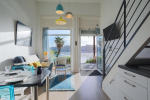 a kitchen and living room with a table and a dining room at Ti Roz - Vue mer in Perros-Guirec