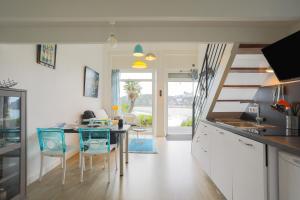 a kitchen and dining room with a table and chairs at Ti Roz - Vue mer in Perros-Guirec