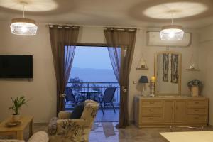 a living room with a view of the ocean at Tigani House in Tyros