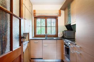 a kitchen with a sink and a window at Ferienhaus Auszeithaus in Zell