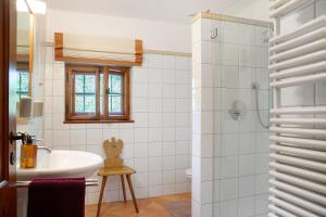 a bathroom with a tub and a sink and a shower at Ferienhaus Auszeithaus in Zell +24 photos