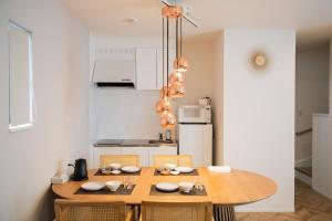 a kitchen with a wooden table and chairs in a kitchen at Kuro in Hakodate +40 photos