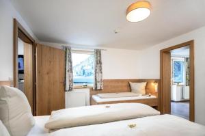 a bedroom with two beds and a window at Haus Sabrina Kreuzjoch in See