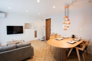 a living room with a table and a couch at Kuro in Hakodate