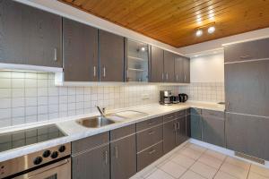 a kitchen with a sink and a counter top at Naturoase Fichtelberg in Fichtelberg +16 photos