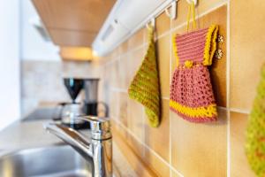 a kitchen with a sink and towels hanging on the wall at Ferienwohnung Kagerhuber in Schönau am Königssee +22 photos