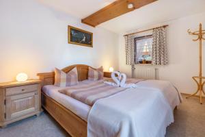 a bedroom with a large bed and a window at Ferienwohnung Kagerhuber in Schönau am Königssee