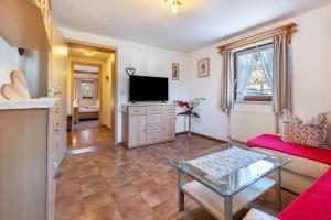 a living room with a couch and a tv at Ferienwohnung Kagerhuber in Schönau am Königssee