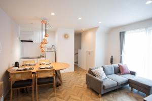 a living room with a table and a couch at Kuro in Hakodate