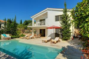 a villa with a swimming pool and a house at Villa Ippokampos Ideales Resort in Kefallonia