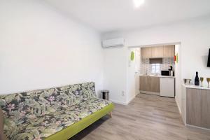 a living room with a couch and a kitchen at Apartamento nº3 - Familiar in Moncarapacho +12 photos