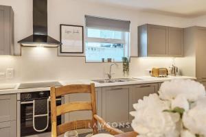 a kitchen with a sink and a counter top at Fit for a King-size Nap I Parking in Windsor +22 photos
