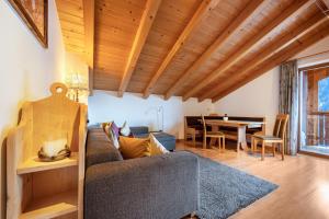a living room with a couch and a table at Raffreiderhof Apt Fichte in Luson