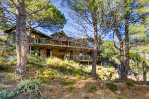 a log home with a deck in the woods at Le Sabel - Cabanon in Mourèze