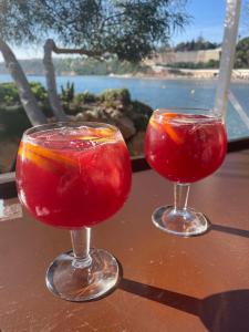 two cocktails in glasses sitting on a table at Spacious ground floor apartment in Punta Prima