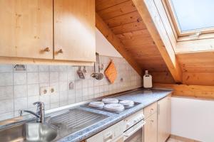 a kitchen with a sink and a stove at Ferienwohnung Kramer in Grainau +20 photos