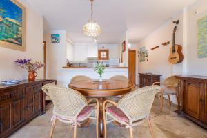 a kitchen and dining room with a table and chairs at Montemar 34 in Port de Soller